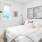 a bedroom with a bed and a plant