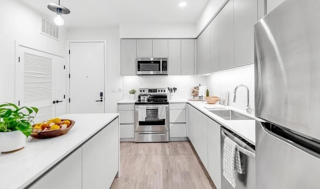 Settle into comfort at The Rinrose a kitchen with white cabinets