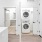 a room with a washing machine and a bed
