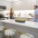 a couple of people stand in a kitchen