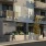 a building with balconies and people walking on the sidewalk