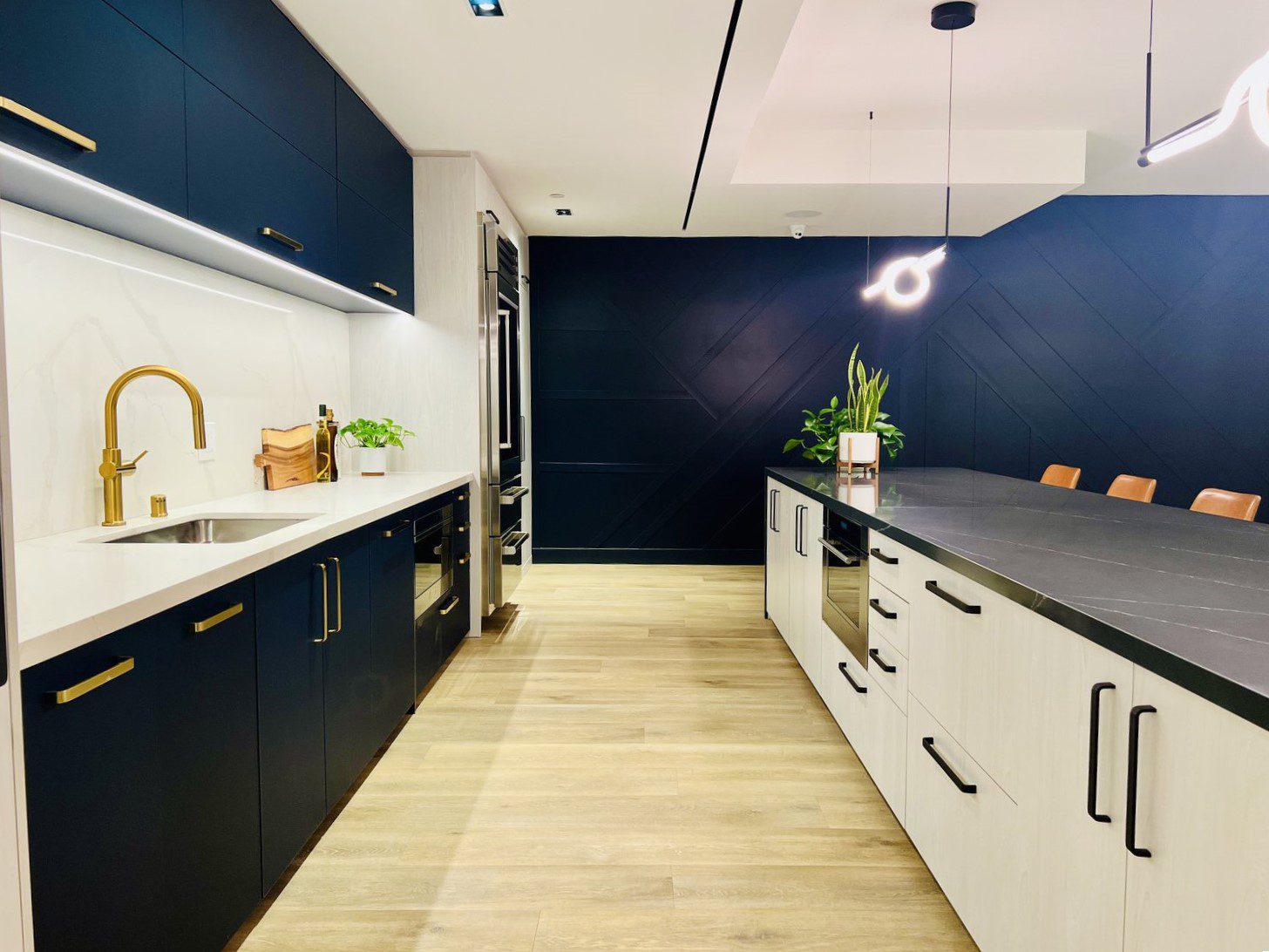 Enhanced Apartments: A blue and white kitchen with black counter tops featuring enhanced amenities.