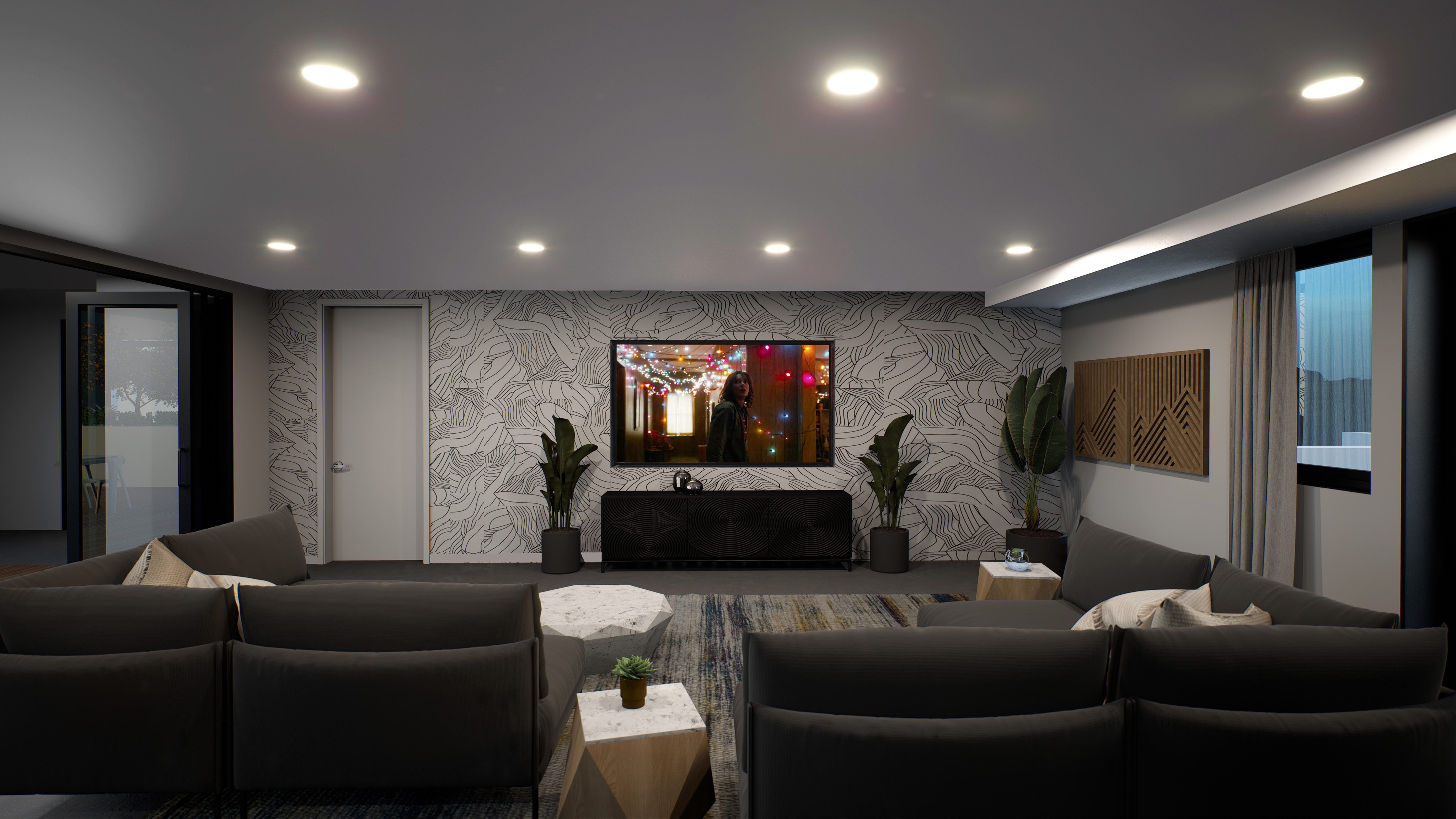 Open lounge room with big dark gray couches and large screen TV on geometric-patterned wall
