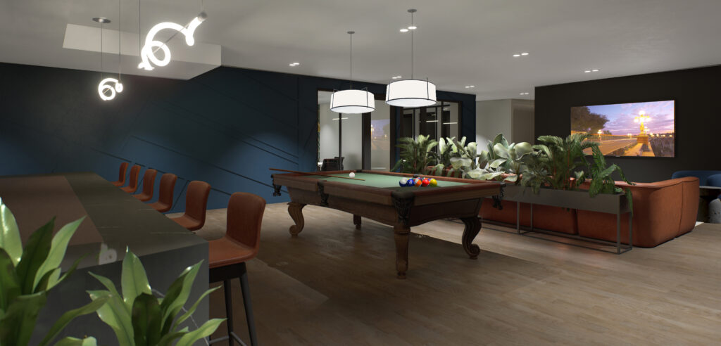 Different angle of dark blue clubhouse room with bar seating on left, dark wooden pool table centered and brown leather couch and TV on right