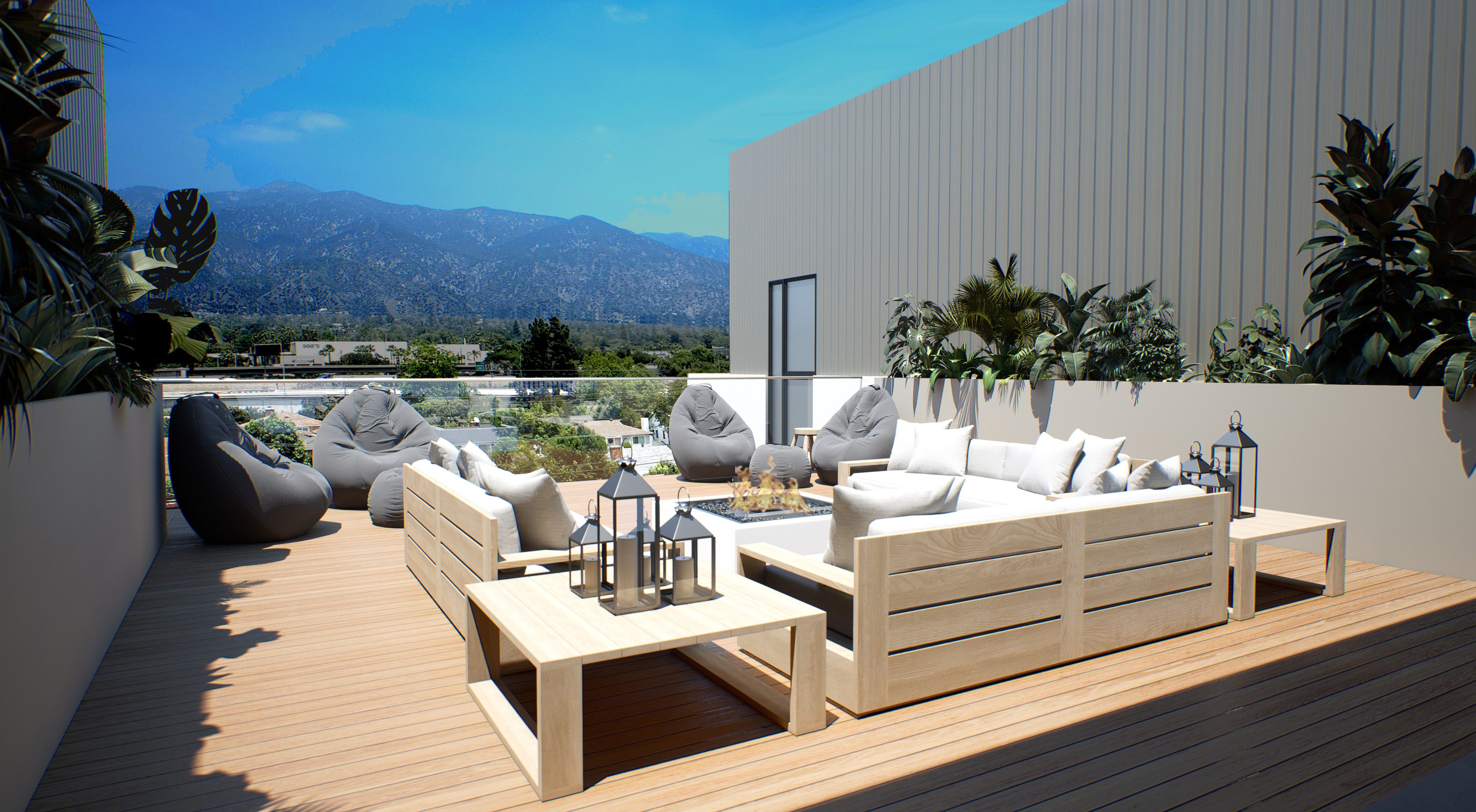 Outdoor patio with cream wooden couches, gray bean bag chairs, fire pit and views of the Pasadena hills