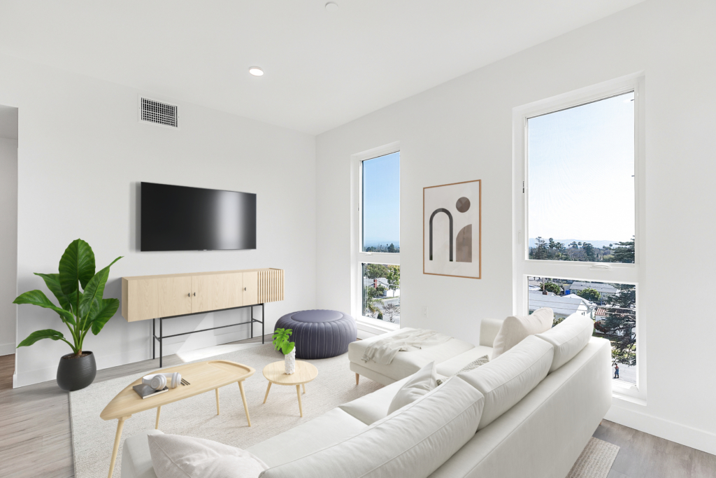A living room in The Rinrose apartment with white furniture and a tv.