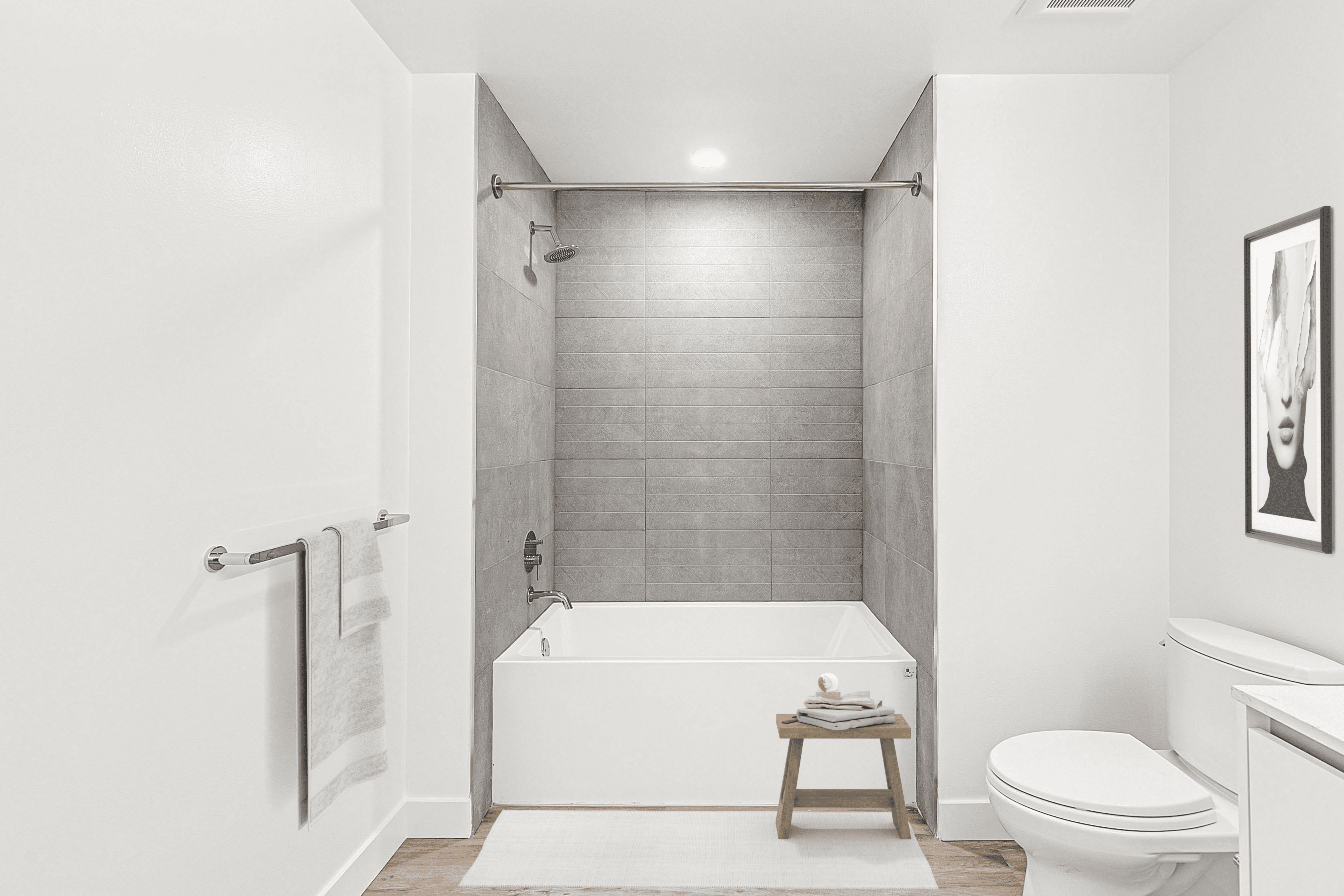 A Multifamily apartment with a bathroom featuring a toilet, sink, and tub at The Rinrose.