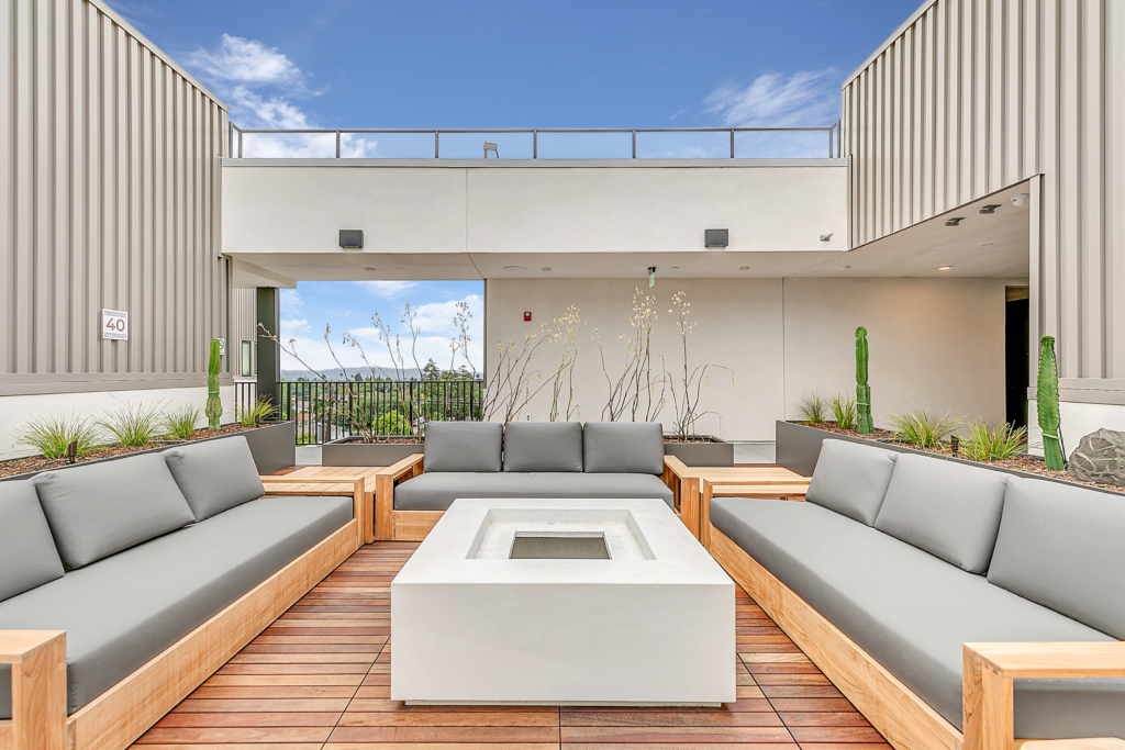 A Pasadena apartment with a patio featuring couches and a fire pit.