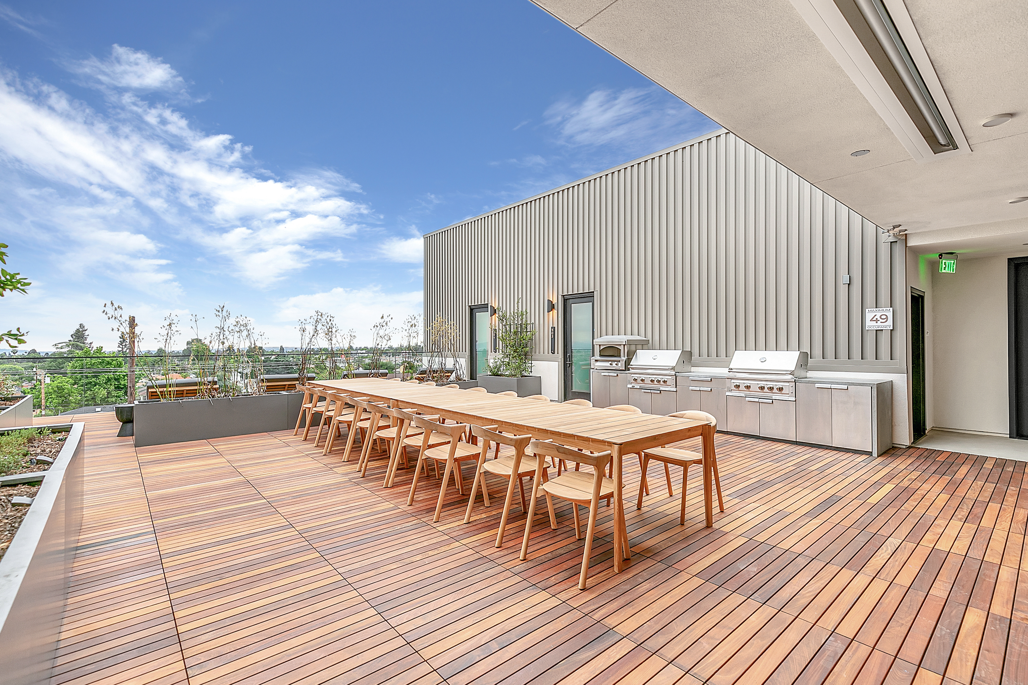 The Rinrose apartment's wooden deck features a table and chairs.