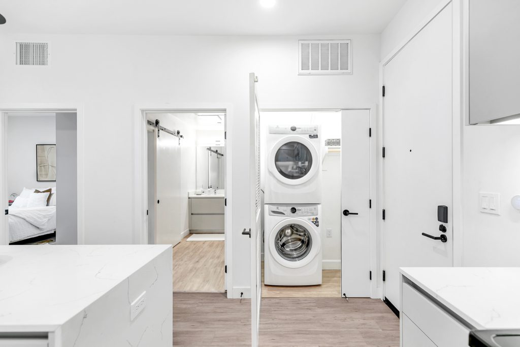 An apartment in Pasadena featuring a white kitchen and washer/dryer.