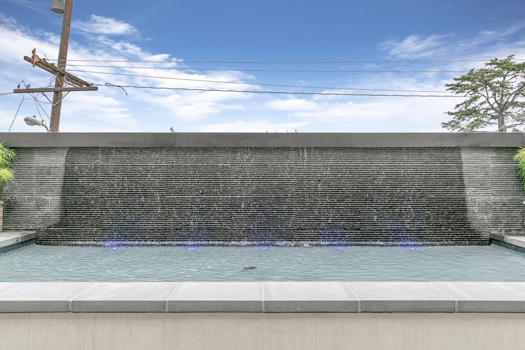 An image of a water feature in front of a house in Pasadena.